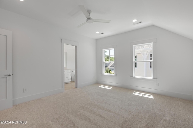 interior space with lofted ceiling, light carpet, and ceiling fan