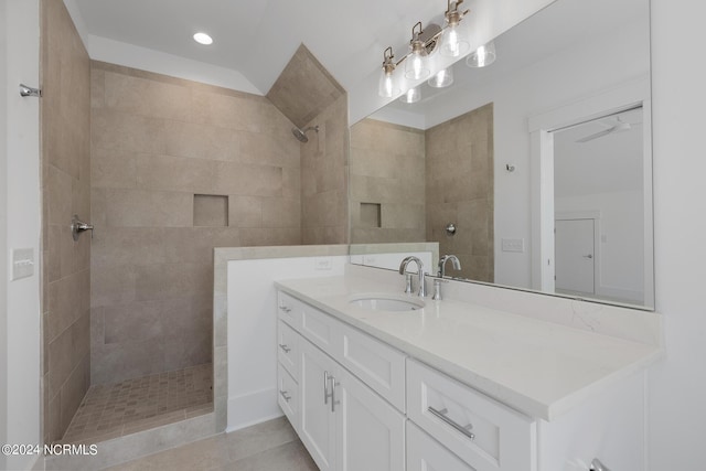 bathroom with vanity and a tile shower