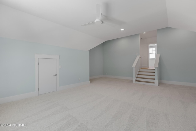 bonus room with lofted ceiling, light colored carpet, and ceiling fan