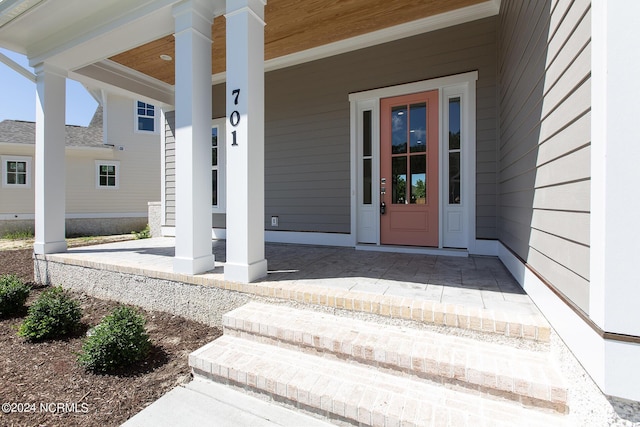 property entrance with covered porch