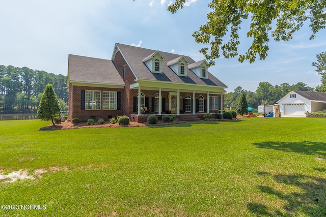 cape cod house with a porch, a front lawn, and a garage