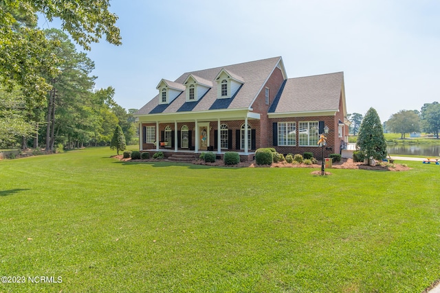 cape cod-style house with a front lawn