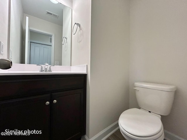 bathroom with toilet and vanity