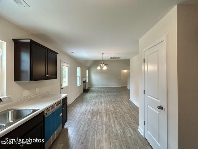 kitchen featuring decorative light fixtures, a notable chandelier, light hardwood / wood-style floors, sink, and dishwasher