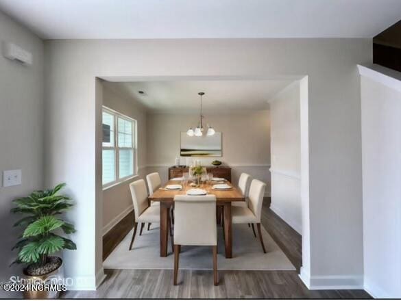 dining area with hardwood / wood-style floors and an inviting chandelier