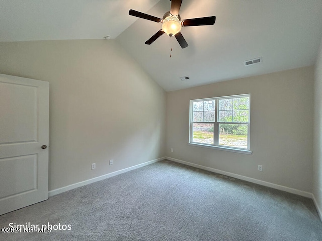 unfurnished room with ceiling fan, lofted ceiling, and light carpet