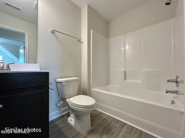 full bathroom with shower / washtub combination, toilet, vanity, and wood-type flooring