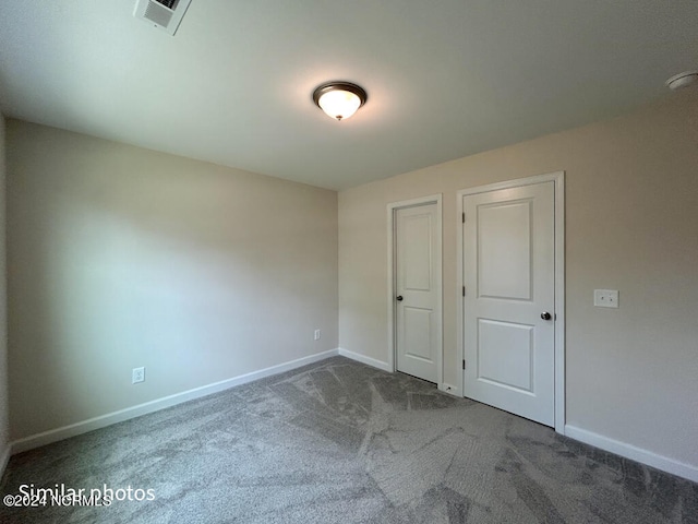 unfurnished bedroom featuring dark carpet