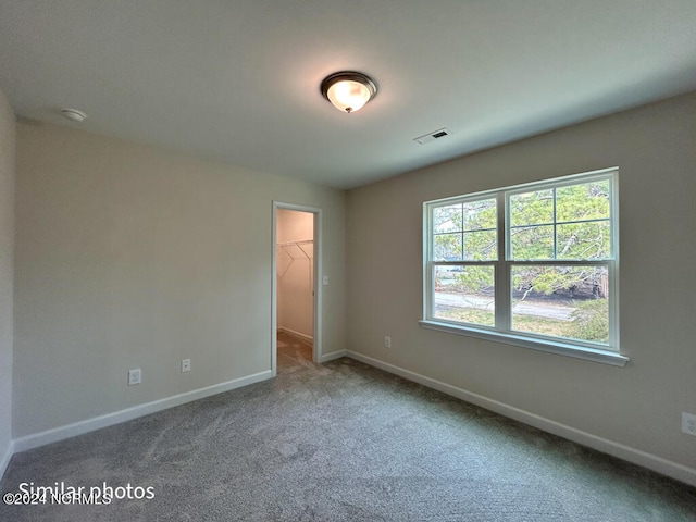 spare room featuring light colored carpet