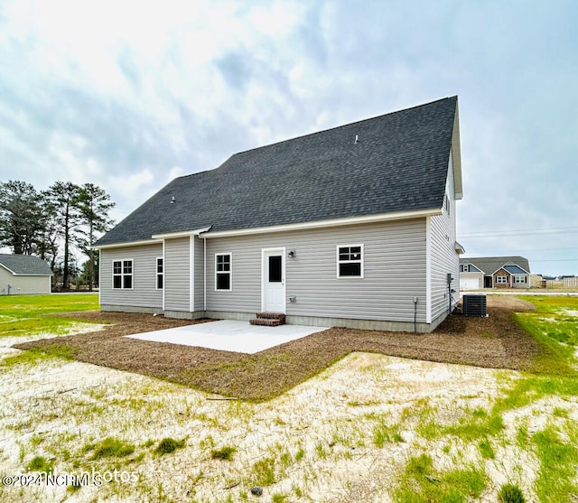 rear view of property with central AC unit and a patio