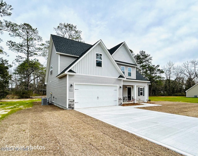 view of front facade with central AC and a garage