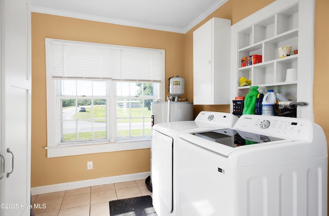 clothes washing area featuring laundry area, ornamental molding, baseboards, electric water heater, and independent washer and dryer