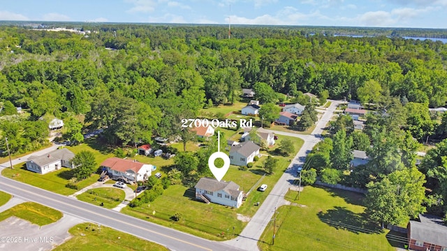 birds eye view of property featuring a view of trees and a residential view