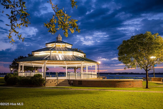 surrounding community with a water view, a gazebo, and a yard