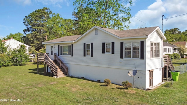 exterior space featuring a wooden deck, stairs, and a front yard