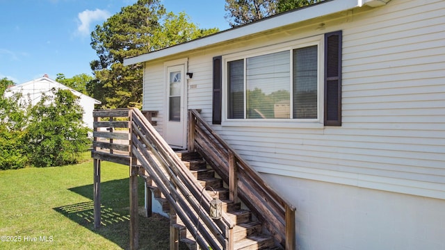 doorway to property with a lawn