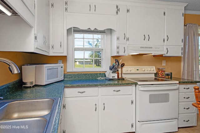 kitchen featuring dark countertops, white appliances, under cabinet range hood, white cabinets, and a sink
