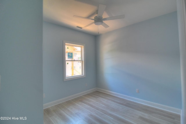 spare room with light hardwood / wood-style floors and ceiling fan