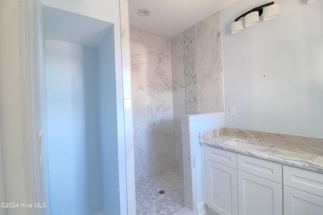 bathroom featuring vanity and tiled shower