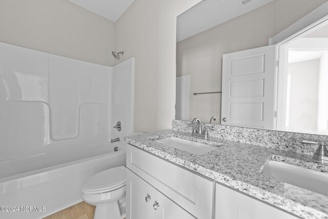 full bathroom featuring shower / tub combination, wood-type flooring, vanity, and toilet