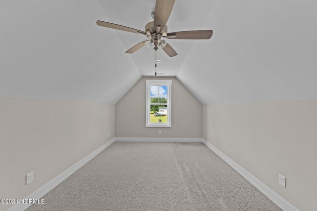 additional living space featuring light carpet, vaulted ceiling, and ceiling fan