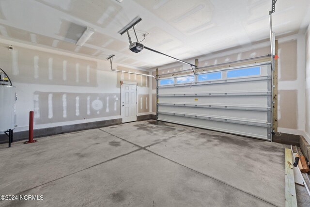 garage with water heater and a garage door opener