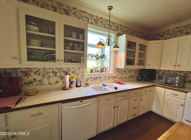 kitchen featuring hanging light fixtures, sink, white cabinetry, and dishwasher