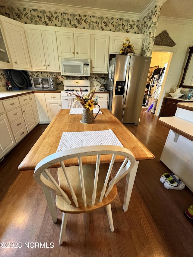 kitchen with dark wood-type flooring, white cabinetry, backsplash, white appliances, and ornamental molding