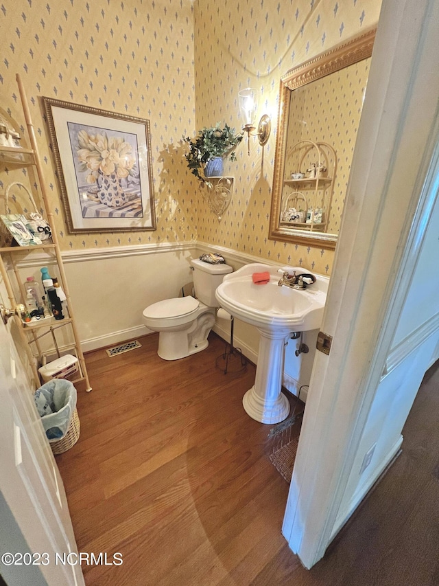 bathroom featuring hardwood / wood-style floors and toilet