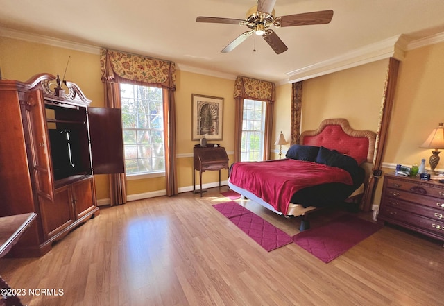 bedroom featuring ornamental molding, ceiling fan, and light wood-type flooring