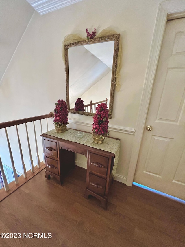 stairs with vaulted ceiling and dark hardwood / wood-style flooring