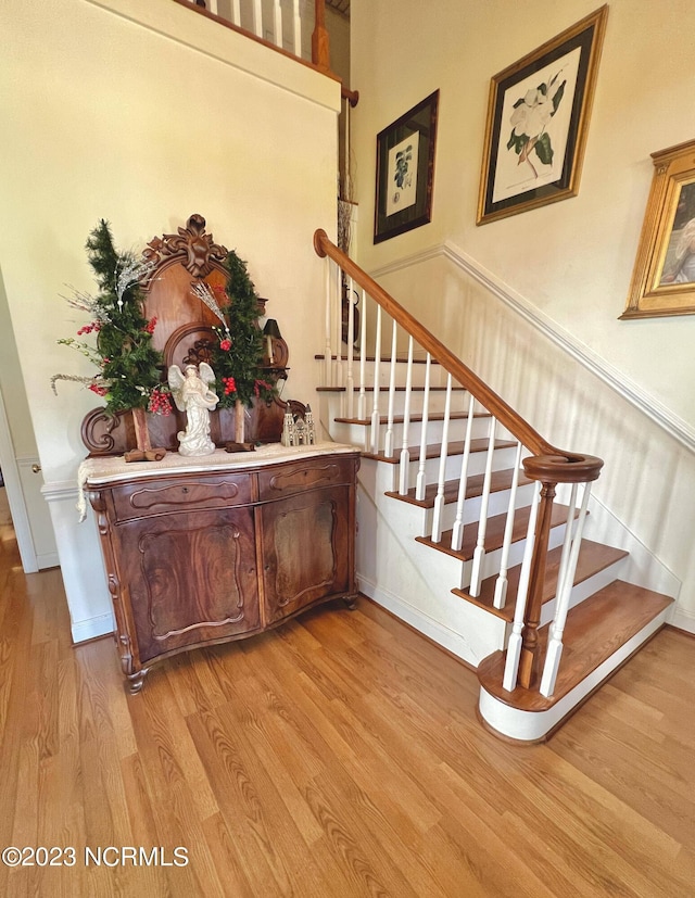 stairs featuring light wood-type flooring