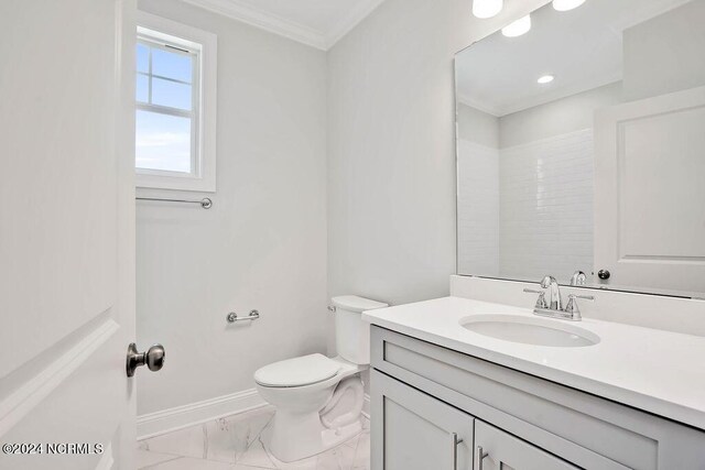 bathroom with a shower, toilet, crown molding, and vanity