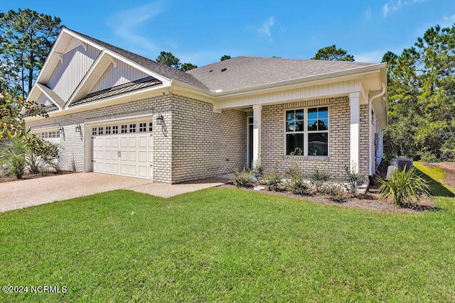 view of front of property with a front yard and a garage