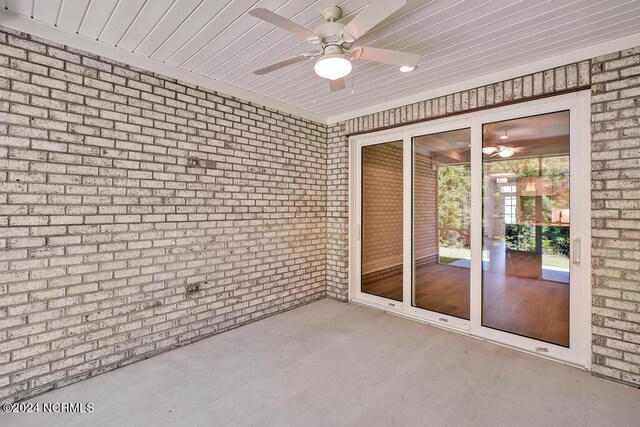 unfurnished sunroom with ceiling fan