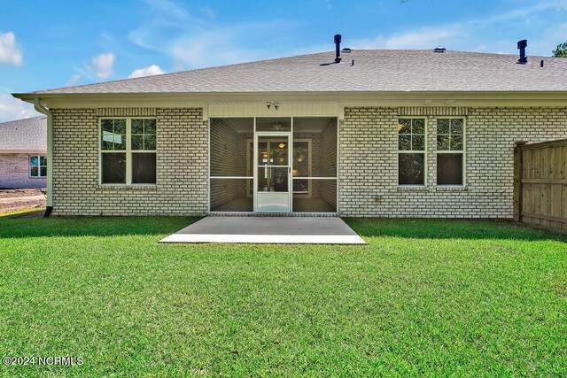 back of house with a patio area and a yard