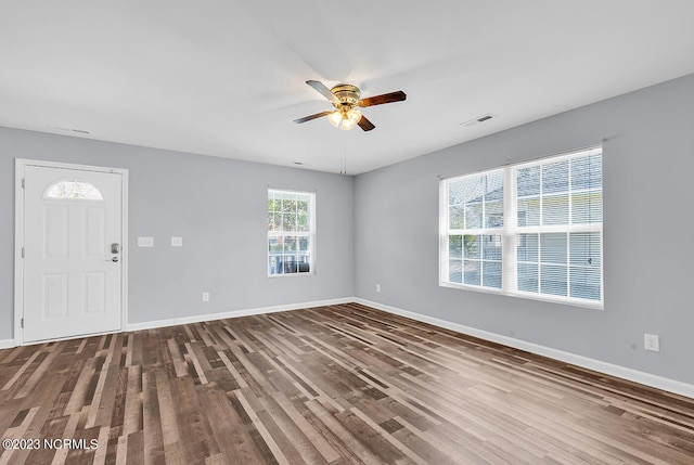 spare room with ceiling fan and dark hardwood / wood-style floors