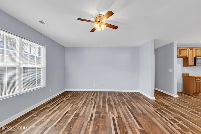 unfurnished room with ceiling fan and dark hardwood / wood-style floors