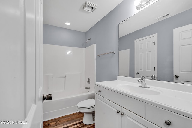 full bathroom featuring  shower combination, toilet, large vanity, and wood-type flooring