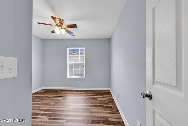 unfurnished room with dark hardwood / wood-style flooring and ceiling fan