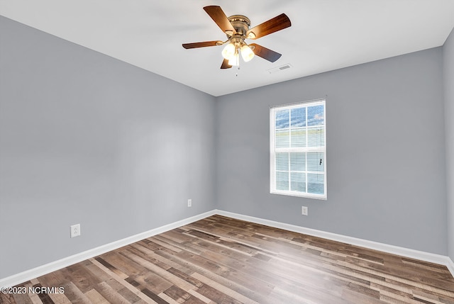 unfurnished room with ceiling fan and dark hardwood / wood-style flooring