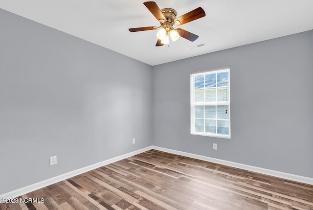 unfurnished room with ceiling fan and dark hardwood / wood-style floors