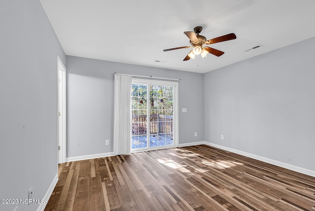 spare room featuring dark hardwood / wood-style floors and ceiling fan