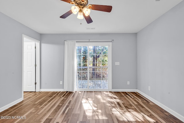 spare room with ceiling fan and dark hardwood / wood-style floors