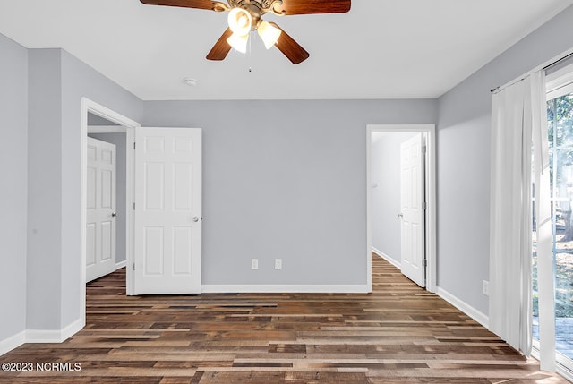 spare room featuring ceiling fan and dark wood-type flooring