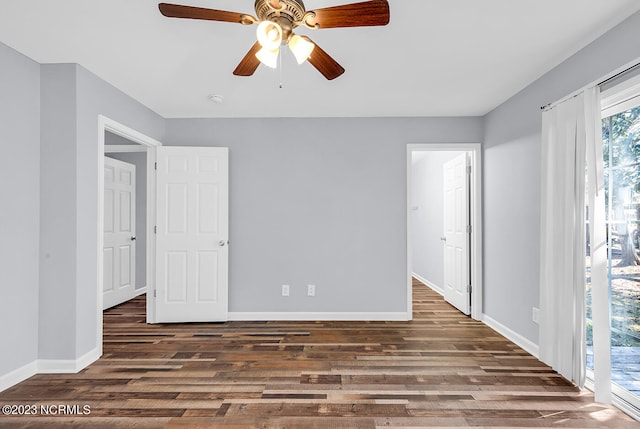 spare room with dark hardwood / wood-style flooring and ceiling fan