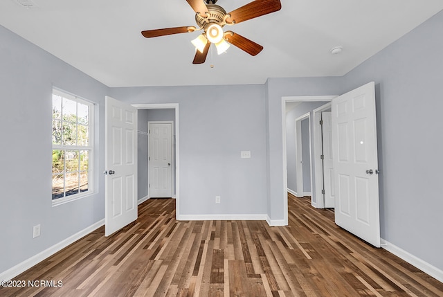 unfurnished bedroom featuring ceiling fan and dark hardwood / wood-style floors