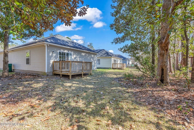 rear view of house with a wooden deck