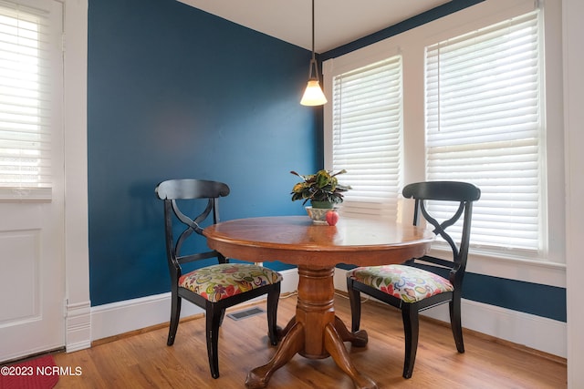 dining room with light wood-type flooring and baseboards