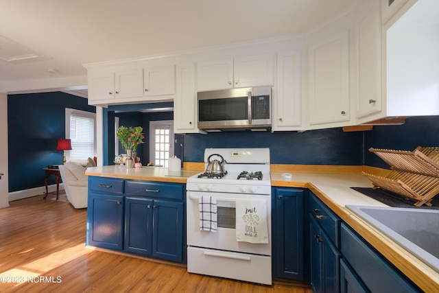 kitchen featuring blue cabinetry, stainless steel microwave, light wood-style floors, white cabinets, and white range with gas stovetop